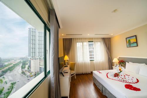 a hotel room with a bed and a large window at Ha Long Dream Hotel in Ha Long
