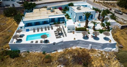 an aerial view of a house with a swimming pool at Ancient Thera Apartments in Kamari