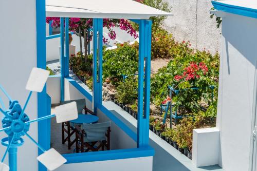 a blue and white balcony with plants at Ancient Thera Apartments in Kamari