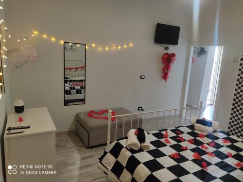 a childs bedroom with a bed and a couch at SCACCO MATTO Holiday House in Taranto