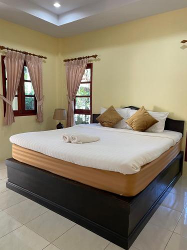 a large bed in a bedroom with a large mattressvisorvisorvisor at Bangtao Hello House in Bang Tao Beach