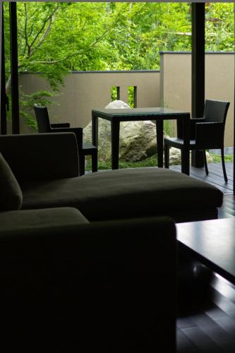 a living room with a couch and a table at Yufuin Bettei Itsuki in Yufuin
