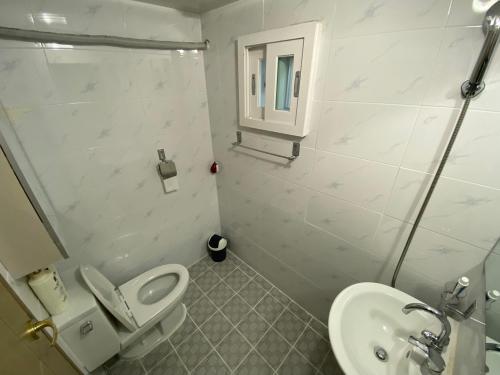 a bathroom with a toilet and a sink at Pungnam House in Jeonju