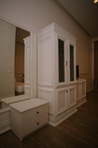a large white room with a large white cabinet at Hotel Konti in Korçë