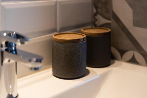 two trash cans sitting on top of a sink at Le Refuge in Namur