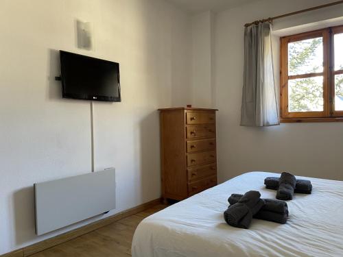 a bedroom with a bed with a flat screen tv at Lujo y Confort en Can Taullar in Pla de l'Ermita