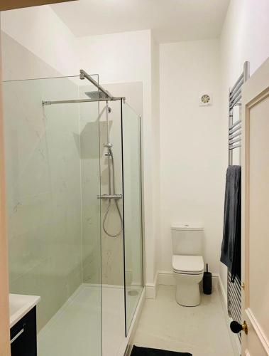 a bathroom with a glass shower and a toilet at NiCheGetaway in Shrewsbury