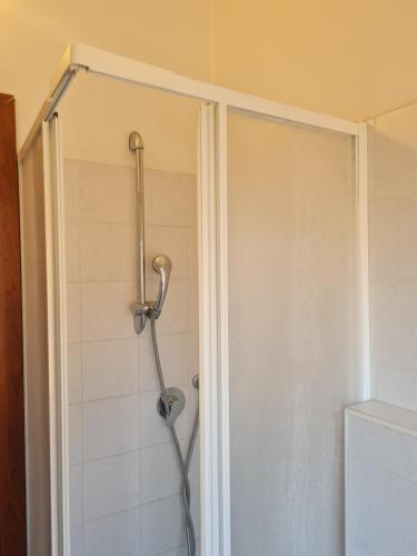 a shower with a shower head in a bathroom at LA PALAZZINA in Rome