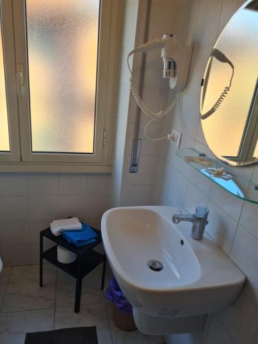 a bathroom with a white sink and a mirror at LA PALAZZINA in Rome