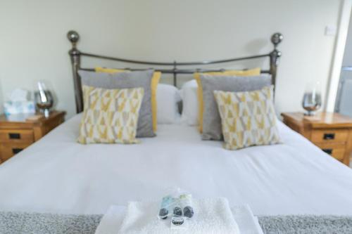 a bed with a pair of shoes sitting on it at Borrowfield Lodge in Derby