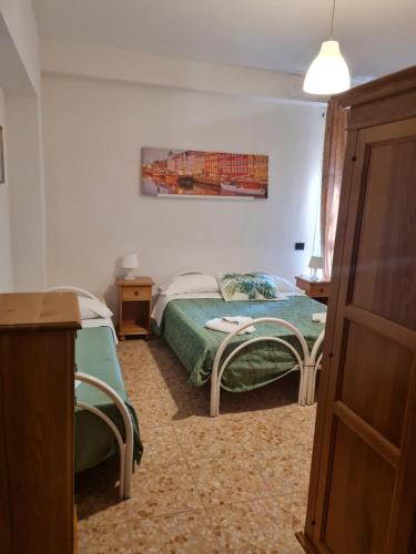 a bedroom with a bed and two chairs in it at LA PALAZZINA in Rome