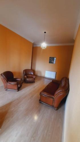 three leather couches sitting in a living room at Brothers khutsishvili wine cellar in Kisiskhevi
