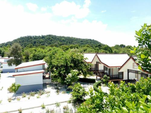 an aerial view of a house with a mountain in the background at Scarlet Sails Resort in Koh Rong Island