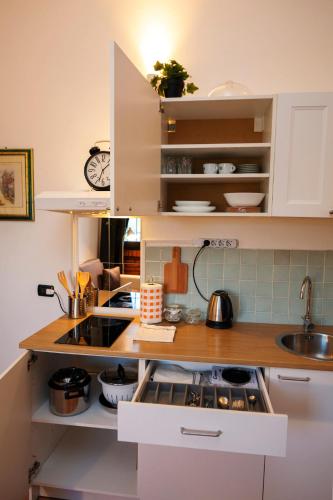 a small kitchen with white cabinets and a sink at Residence San Raffaele 1 in Milan