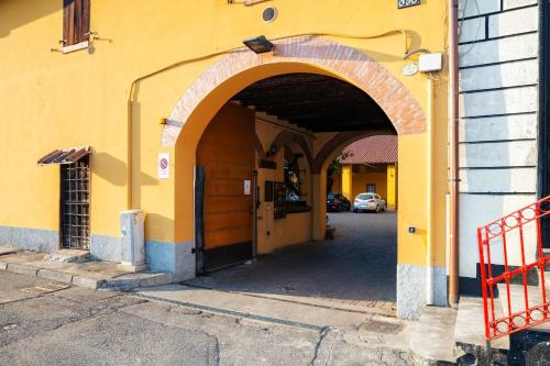 an entrance to a yellow building with an archway at Residence San Raffaele 1 in Milan