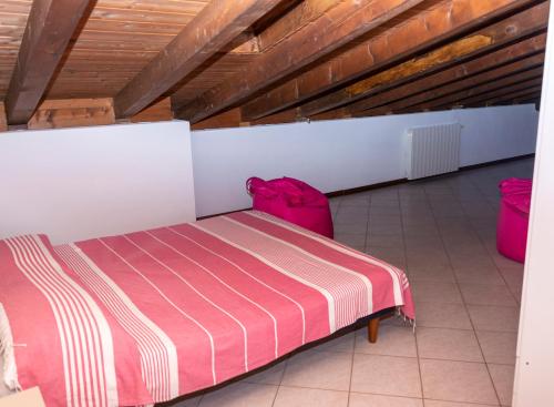 a room with a bed and two pink bags at Hotel Villa Rosa in Porto Azzurro