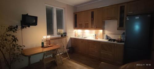 a kitchen with a table and a counter with candles at Guest House Dacha in Kyiv