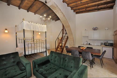 a living room with a table and chairs and a kitchen at Pentasino Traditional House in Ayios Theodhoros
