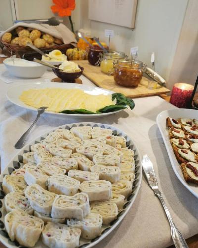 a table topped with plates of food on a table at Breanäs Hotell in Immeln