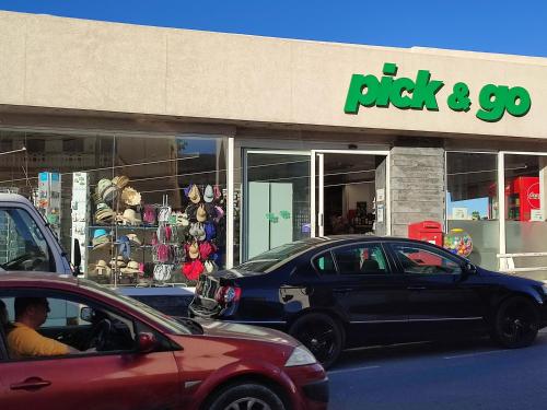 a car parked in front of a rock and go store at BEACHFRONT with Seaviews Apartment No56 Award Winner Unbeatable Location for Closeness to the Sea Ideal for Guests looking for Winter Spring and Autumn Breaks in Sunny Malta Also Ideal for Coastal Hikers in Mellieħa