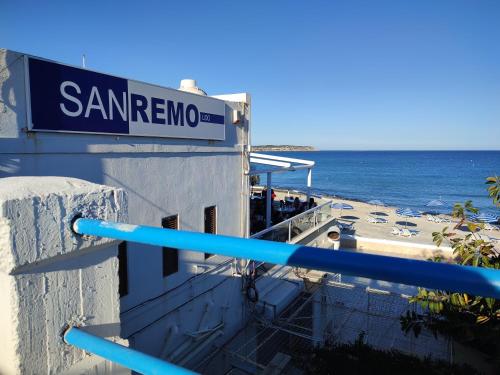 a sign on the side of a building next to the ocean at BEACHFRONT with Seaviews Apartment No56 Award Winner Unbeatable Location for Closeness to the Sea Ideal for Guests looking for Winter Spring and Autumn Breaks in Sunny Malta Also Ideal for Coastal Hikers in Mellieħa