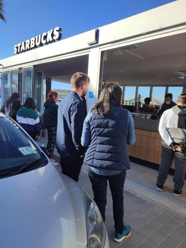 a group of people standing outside of a food truck at BEACHFRONT with Seaviews Apartment No56 Award Winner Unbeatable Location for Closeness to the Sea Ideal for Guests looking for Winter Spring and Autumn Breaks in Sunny Malta Also Ideal for Coastal Hikers in Mellieħa