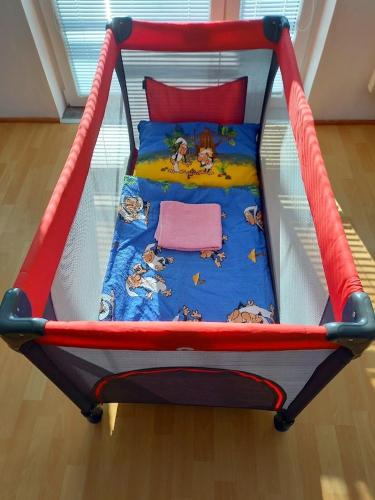 a childs bed with a red and white canopy at Chalupa Liptovský Mikuláš in Liptovský Mikuláš