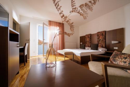 ein Wohnzimmer mit einem Sofa und einem Tisch in der Unterkunft Hotel Garni Toscanina - Adults Only in Bad Radkersburg