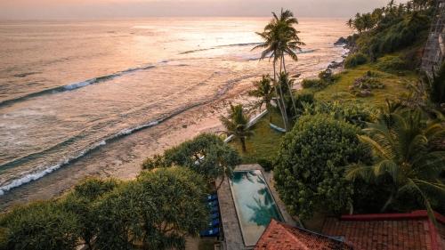 an aerial view of a beach with a swimming pool at Saltasia Boutique Beach Villa in Mirissa