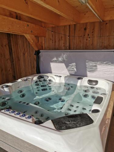 a bath tub filled with water sitting on a table at Superbe Maison Jacuzzi+Piscine au cœur des vignes in Pfaffenheim