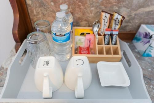 a table with two white controllers and a bottle of water at Borrowfield Lodge in Derby