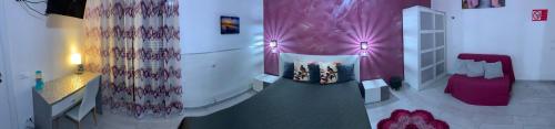 a room with a bed and a purple curtain at La Terrazza della Nonna in Palermo