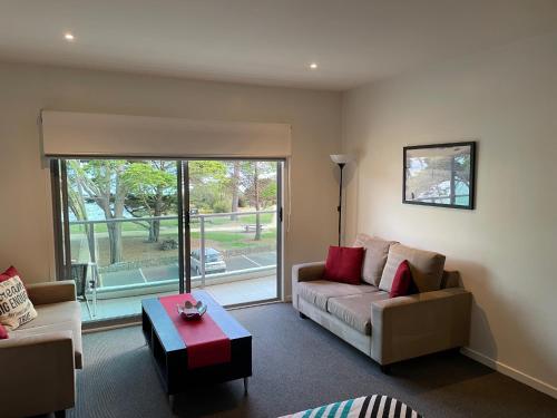 a living room with a couch and a table at Waterfront@Waves in Cowes