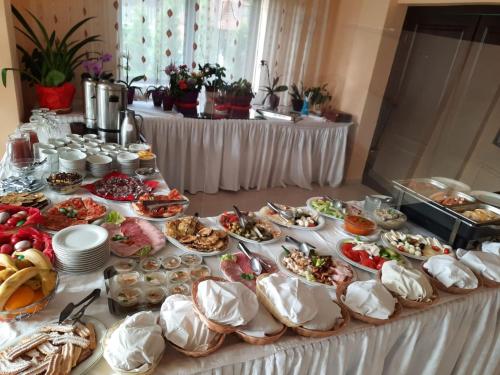 a buffet table with a lot of food on it at HOTEL CARPATHIA in Remeţi