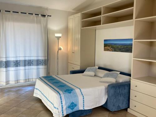 a bedroom with a large bed and shelves at Residence Floreal in San Pasquale