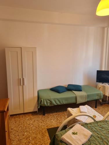 a small room with two beds and a door at LA PALAZZINA in Rome