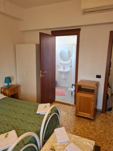 a bedroom with a bed and a bathroom with a sink at LA PALAZZINA in Rome