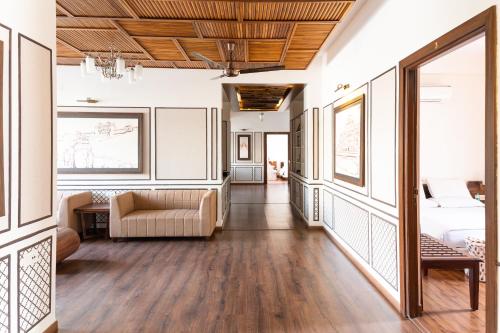 a living room with a bed and a couch at Bhola Bhawan Bed and Breakfast in Jaipur