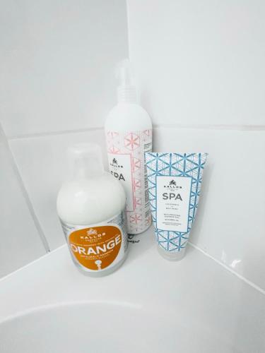 a shelf with a bottle of shaving cream and a container of soap at Balcsitthon Apartmanok in Siófok
