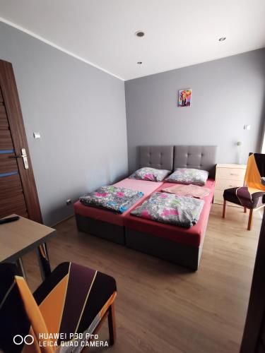 a bedroom with a bed and a table and chairs at Noclegi Mazur przysiersk in Przysiersk