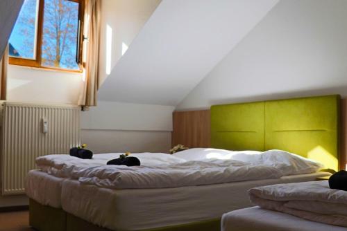 a bedroom with two beds with black cats on them at FitApartman in Mitterfirmiansreut