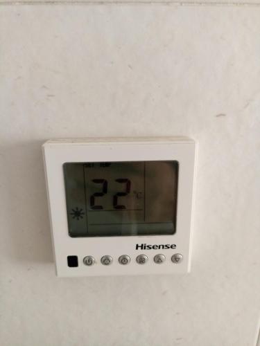a white clock on the ceiling of a room at La Perla Azul Playa - Terraza al Sol in Roquetas de Mar