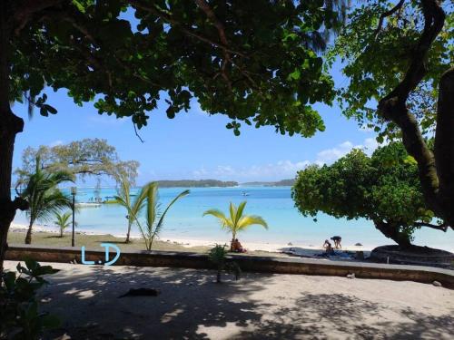 a view of a beach with trees and the water at Vacances Le Nereide Blue Bay in Blue Bay