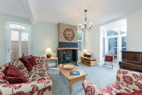 a living room with a couch and a fireplace at Borrowfield Lodge in Derby