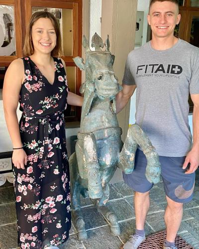 a man and a woman standing next to a statue at Settle Inn Tourist Lodge in Kandy