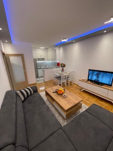 a living room with a large couch and a television at Sofija in Trebinje