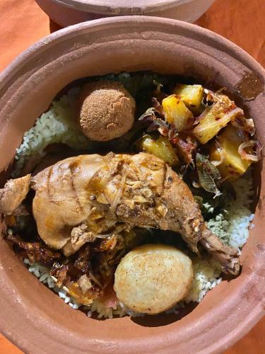 a bowl of food with meat and vegetables on rice at Settle Inn Tourist Lodge in Kandy