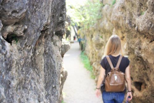 a woman walking down a path between rocks at Casa el Escalerón in Uña