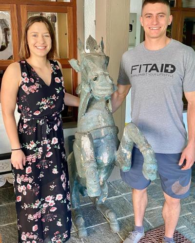 a man and a woman standing next to a statue at Settle Inn Tourist Lodge in Kandy