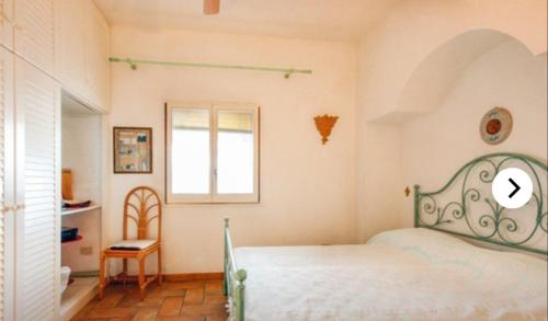 a bedroom with a bed and a window at Villa Tina Tropea Costa dei Monaci Parghelia, sabbia fine e bianca e mare cristallino in Mandaradoni